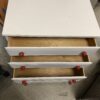 Compact White 4 Drawer Dresser with Red Knobs
