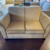 Tan Loveseat with Brown Piping