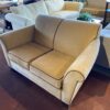 Tan Loveseat with Brown Piping