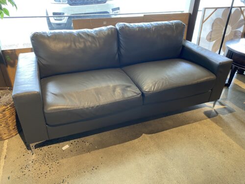 Grey Leather Sofa with Tufted Back and Decorative Legs