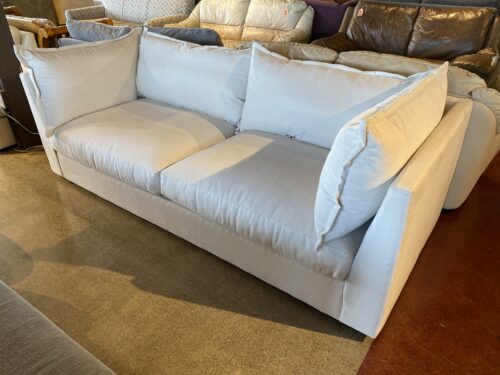 Cream Colored Couch with Pillow Back and Ottoman