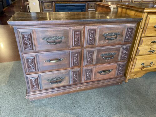 Dark Wood Dresser with Decorative Square Panels and Ornate Pulls