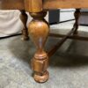 Large Round Leather Ottoman with Colonial Style Wooden Legs