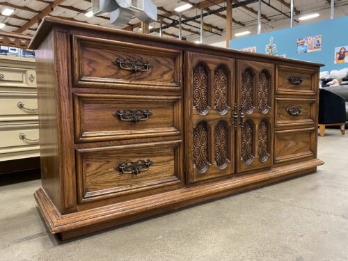 Dark Stained Triple Dresser with Ornate Carved Cabinet Doors