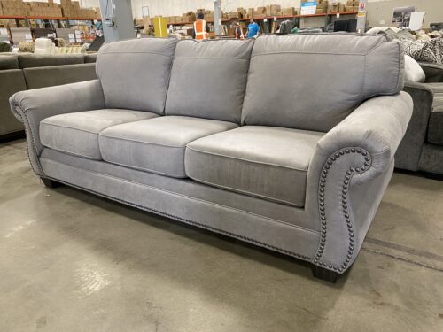 ASHLEY FURNITURE Stone Grey Suede-Like Roll Arm Sofa with Nailhead Trim