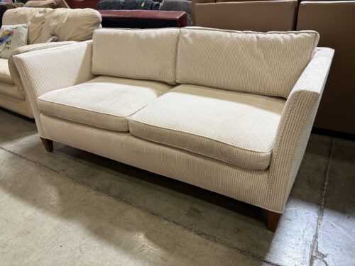 Beige and Cream Corduroy Low Back Loveseat with Dark Wood Feet