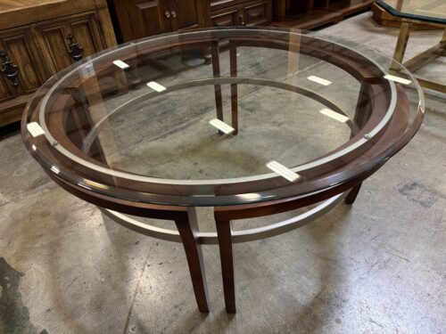 Contemporary Round Dark Finished Coffee Table with Silver Accents and Thick Beveled Glass Top