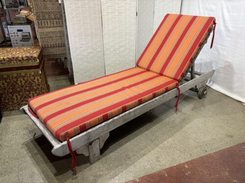 Outdoor Chaise Lounge Chair with a Vibrant Striped Orange and Red Cushion