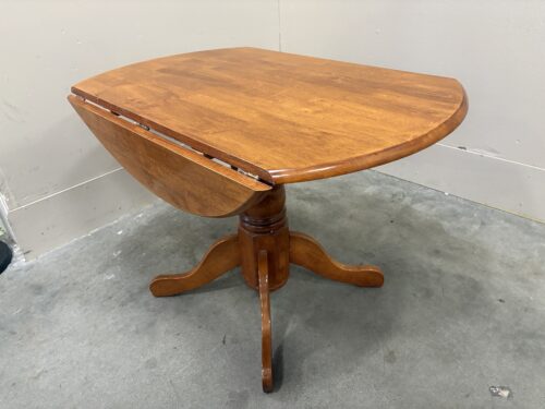 Round Honey Oak Finished Drop-Leaf Dining Table with Pedestal Base