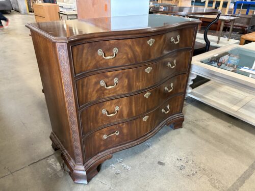 HEIRLOOM HERITAGE FURNITURE Warm Finish Wooden Serpentine Front 4 Drawer Dresser with Swing Pulls and Carved Wood Accents