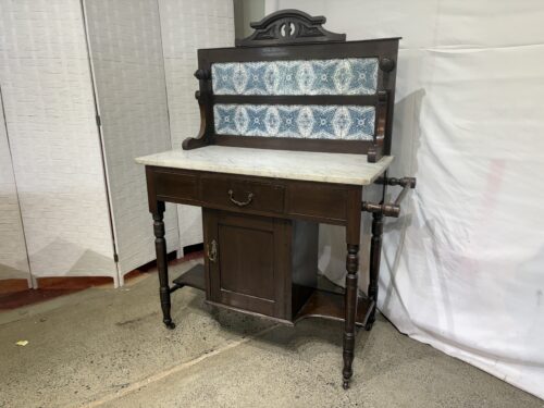 Antique Washstand with White Marble Top and Vibrant Blue-and-White Patterned Ceramic Tile Backsplash