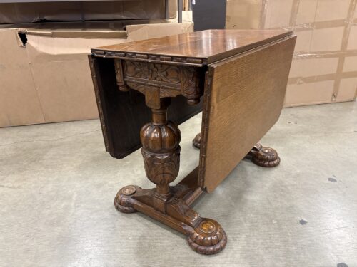 Antique Wooden Drop-Leaf Dining Table with Ornate Carved Trestle Base