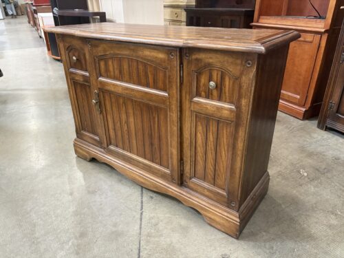 Vintage Oak Sideboard with Raised Panel Accents and Brass Tone Hardware