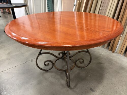 Round Bright Cherry Finished Dining Table with Metal Scrollwork Pedestal Base